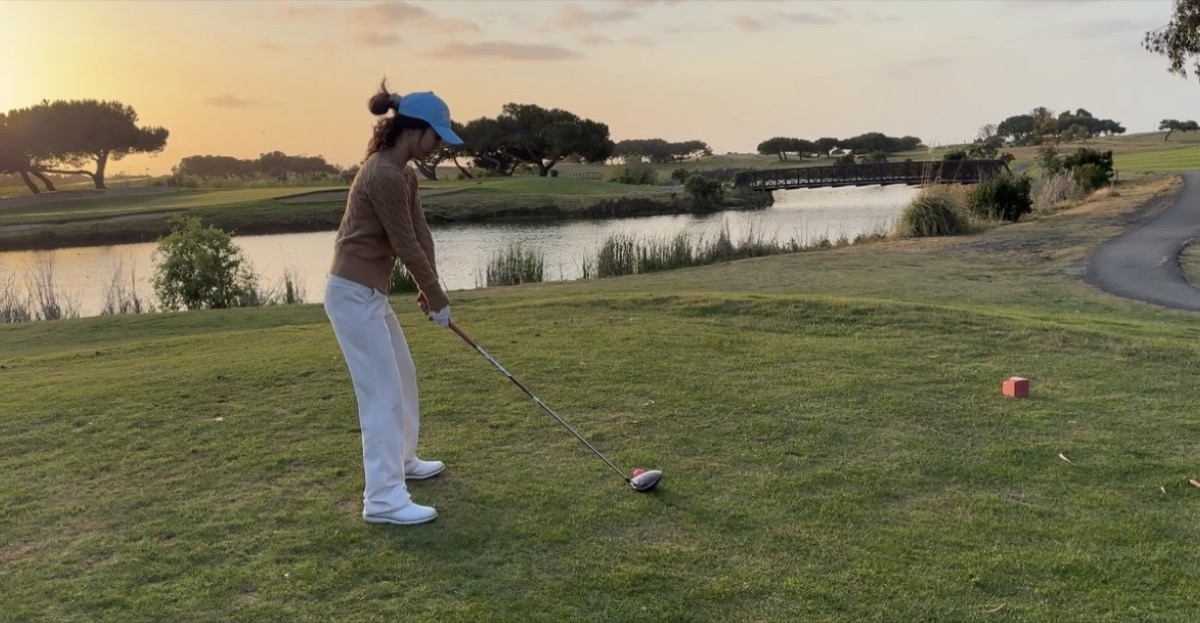 Mengmeng playing golf at sunset